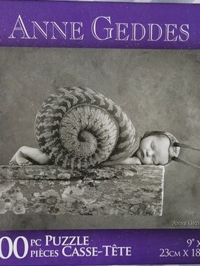 Anne Geddes 100-Piece Puzzle – Baby Snail black And white photo